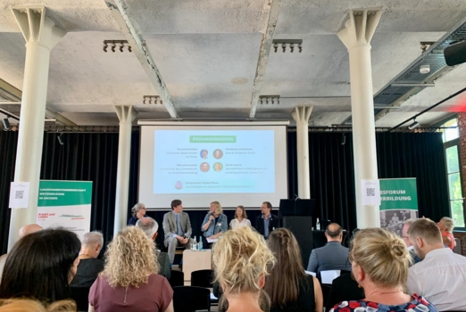 Blick aus dem Publikum auf die Podiumsdiskussion des Landesforums Weiterbildung.